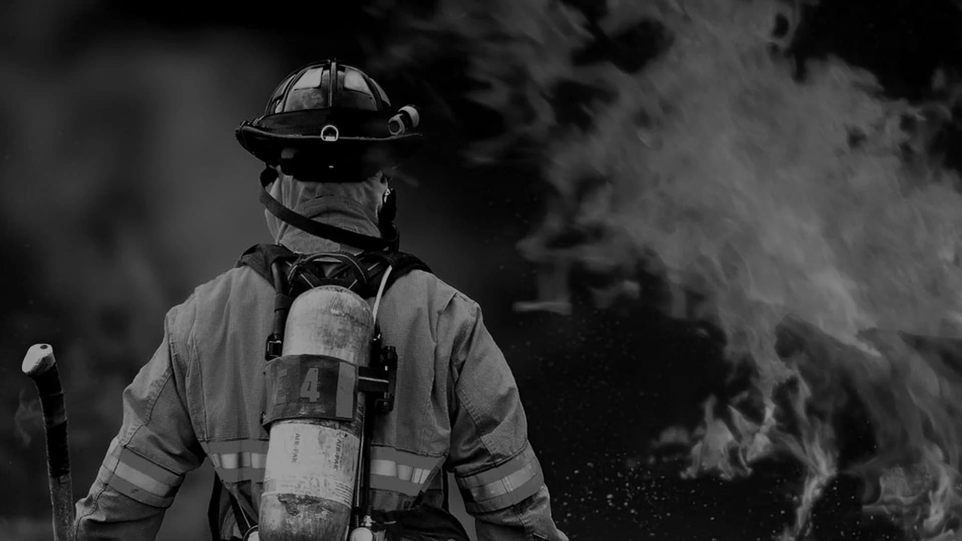 Firefighter in front of a house fire