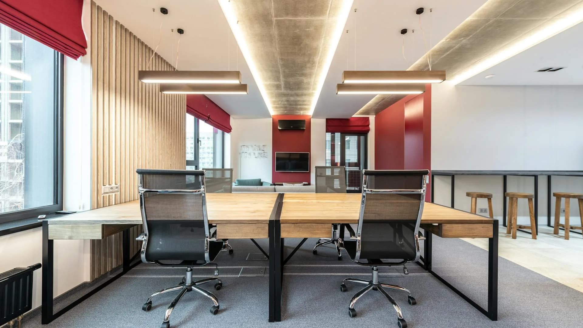 An empty modern office with a long desk and two chairs