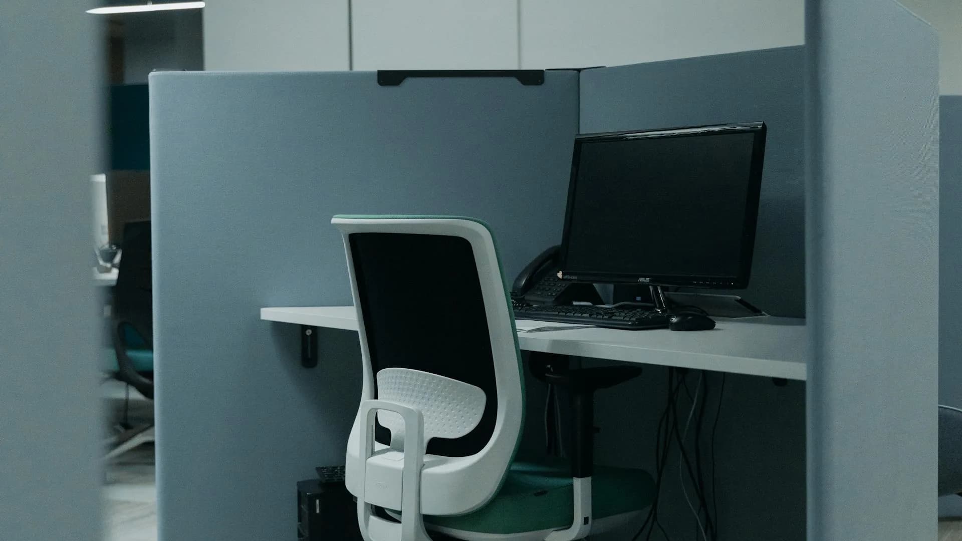 A clear desk with a laptop and a few supplies